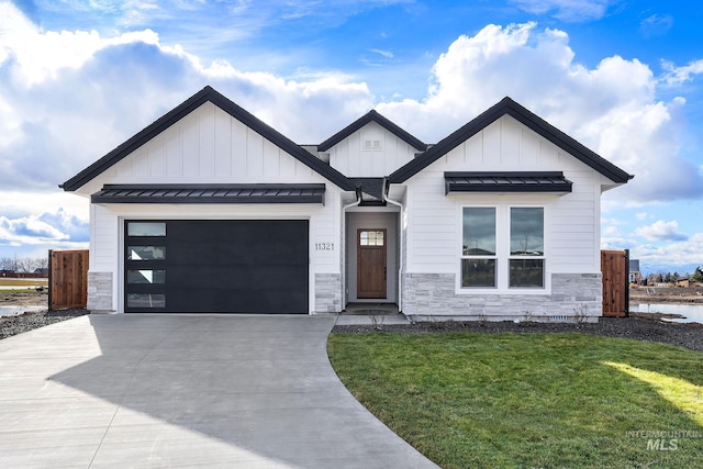 modern farmhouse featuring a front lawn and a garage