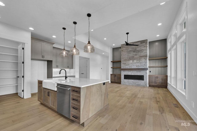 11321 S Yeoman St, Kuna, ID 83634 - kitchen featuring a sink, stainless steel dishwasher, light wood-style flooring, a ceiling fan, and light countertops