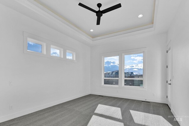 11321 S Yeoman St, Kuna, ID 83634 - spare room featuring ceiling fan, a raised ceiling, baseboards, dark carpet, and recessed lighting
