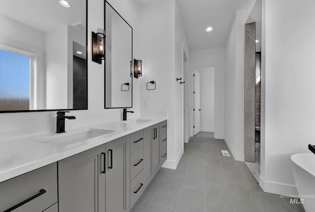 bathroom with vanity and a tub