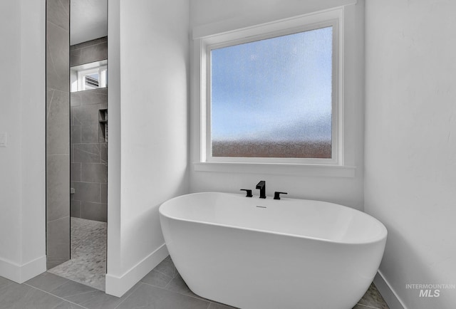 bathroom featuring tile patterned flooring, a healthy amount of sunlight, and shower with separate bathtub