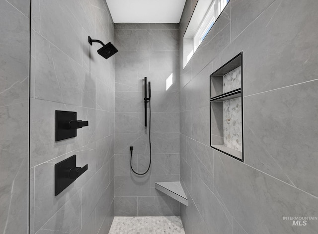 bathroom with a tile shower