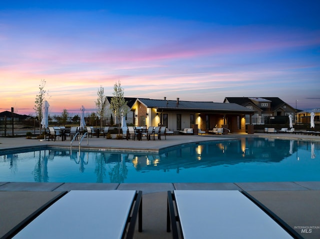 11321 S Yeoman St, Kuna, ID 83634 - pool at dusk with a community pool and a patio area