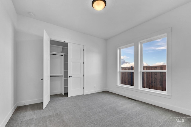 unfurnished bedroom with a closet and carpet floors