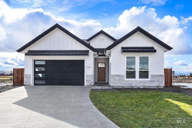 11321 S Yeoman St, Kuna, ID 83634 - modern farmhouse style home with stone siding, concrete driveway, a standing seam roof, board and batten siding, and a front lawn