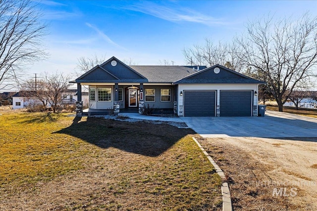 view of front of house featuring a garage, concrete driveway, and a front lawn