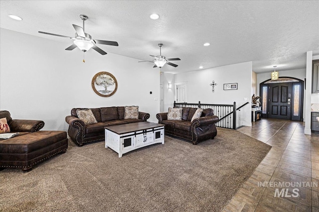 living room featuring a textured ceiling and recessed lighting