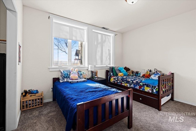 bedroom featuring carpet and baseboards