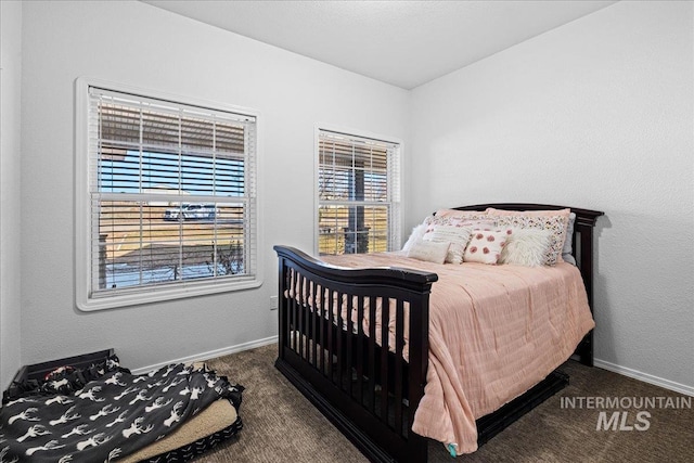 bedroom featuring carpet floors and baseboards