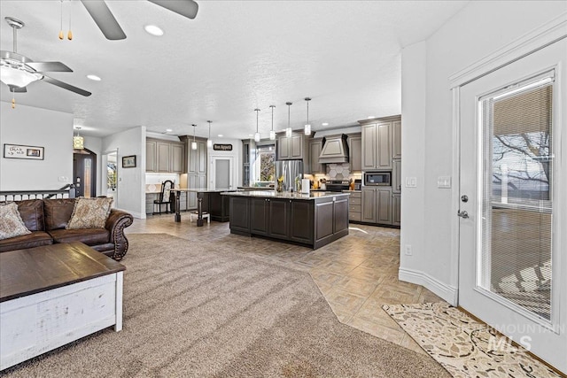 living area featuring recessed lighting, ceiling fan, a textured ceiling, and baseboards