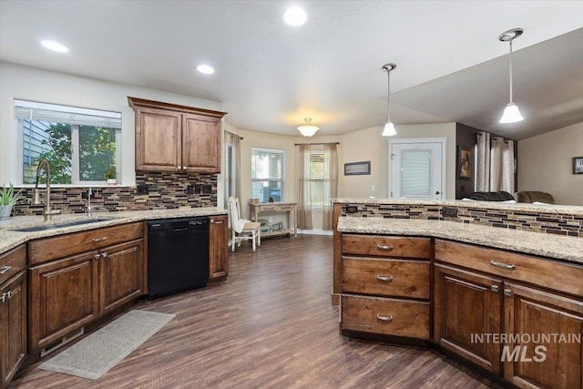 kitchen with dark wood-style floors, light stone countertops, a sink, black dishwasher, and decorative light fixtures