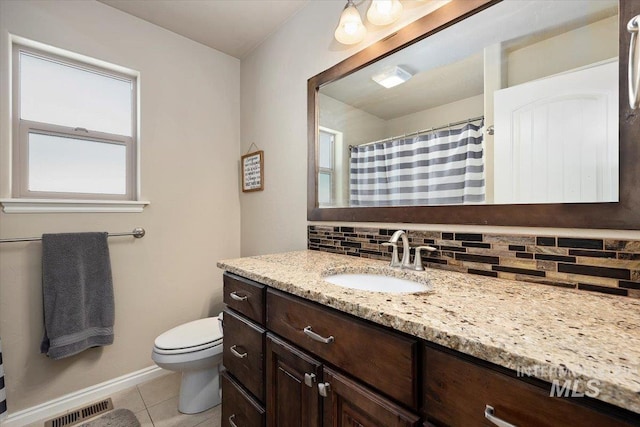 full bathroom featuring tile patterned floors, visible vents, toilet, tasteful backsplash, and vanity