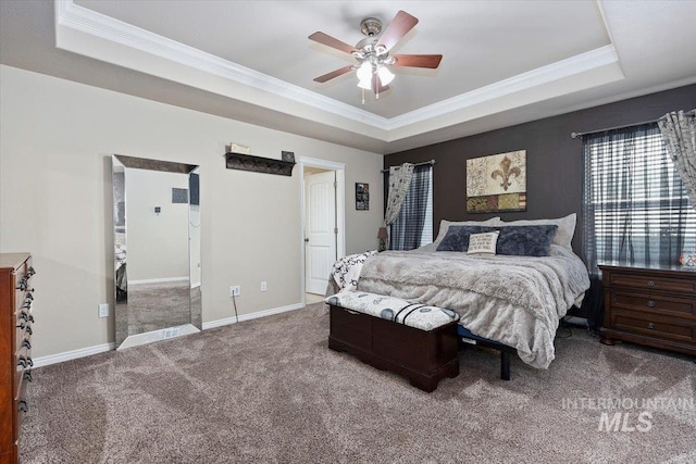 carpeted bedroom featuring baseboards, a raised ceiling, and ornamental molding