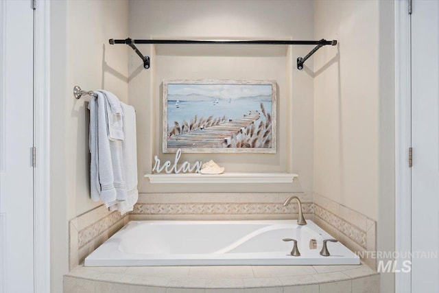 bathroom with a relaxing tiled tub