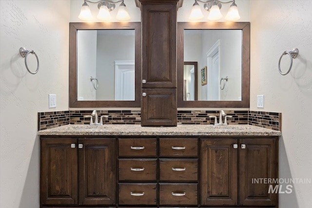 full bathroom featuring double vanity, decorative columns, backsplash, and a sink