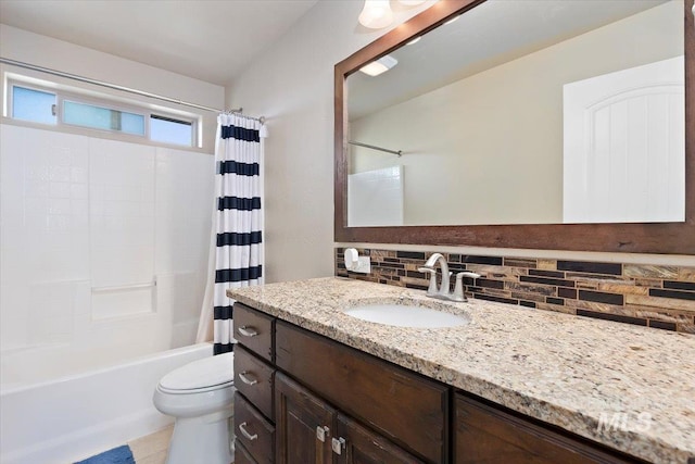 bathroom featuring vanity, toilet, shower / bathtub combination with curtain, and tasteful backsplash