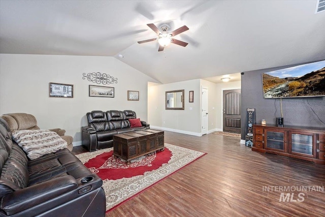 living area featuring visible vents, a ceiling fan, wood finished floors, baseboards, and vaulted ceiling