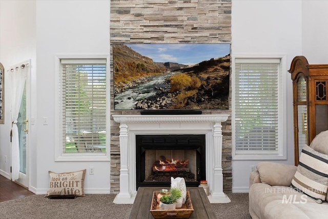 34 S 150 E, Burley, ID 83318 - carpeted living area featuring a large fireplace, baseboards, and a towering ceiling