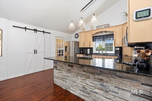 34 S 150 E, Burley, ID 83318 - kitchen featuring appliances with stainless steel finishes, light brown cabinets, decorative backsplash, dark wood-type flooring, and a sink