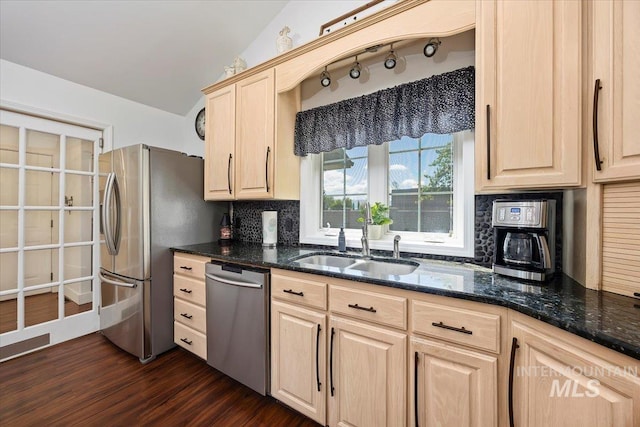 34 S 150 E, Burley, ID 83318 - kitchen featuring appliances with stainless steel finishes, a sink, light brown cabinetry, decorative backsplash, and dark stone counters