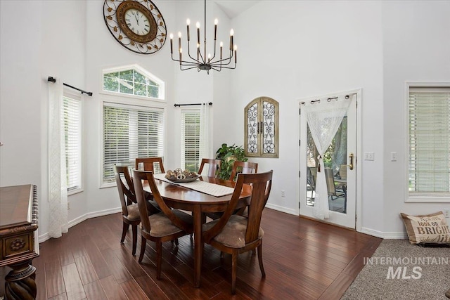 34 S 150 E, Burley, ID 83318 - dining room with dark wood-type flooring, a chandelier, a high ceiling, and baseboards