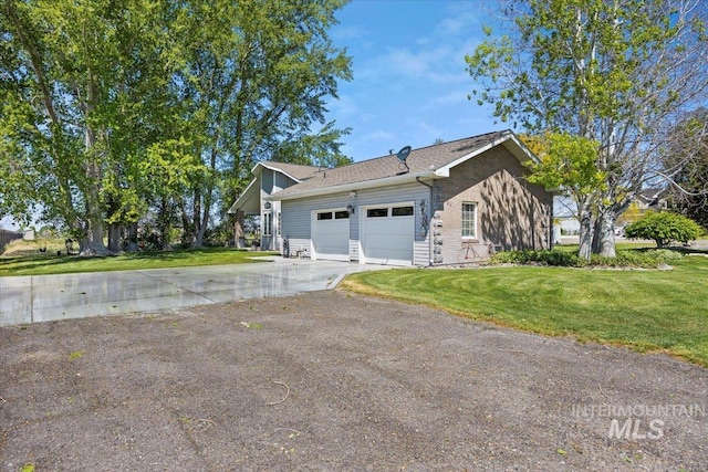 34 S 150 E, Burley, ID 83318 - view of side of property featuring a garage, driveway, and a yard