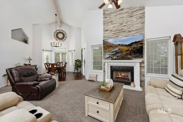 34 S 150 E, Burley, ID 83318 - living area with high vaulted ceiling, a chandelier, beam ceiling, ceiling fan, and a warm lit fireplace