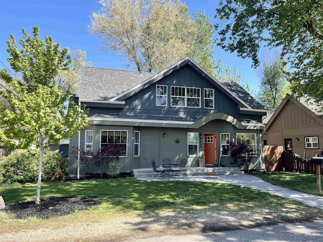 view of front facade featuring roof with shingles and board and batten siding