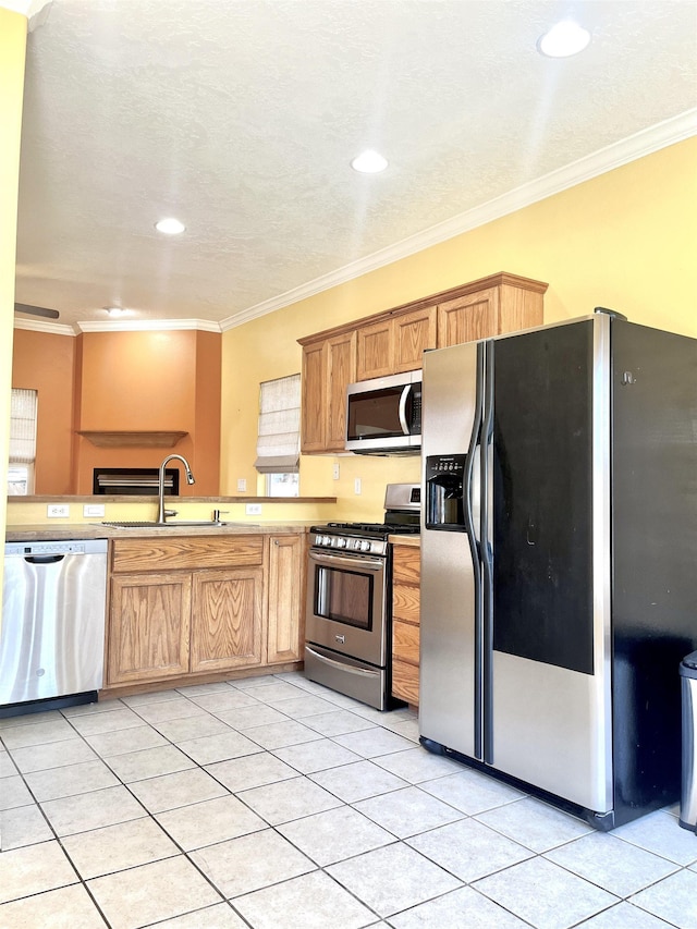 2910 W Hazel St, Boise, ID 83702 - kitchen with appliances with stainless steel finishes, a sink, light tile patterned floors, crown molding, and recessed lighting