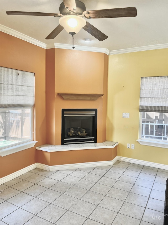 2910 W Hazel St, Boise, ID 83702 - unfurnished living room featuring tile patterned flooring, ornamental molding, ceiling fan, a large fireplace, and baseboards