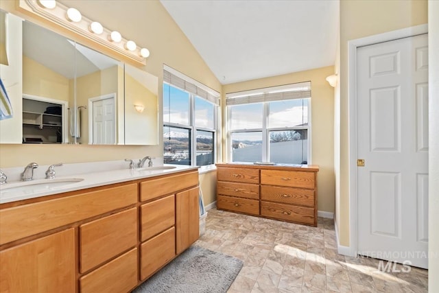 bathroom featuring vanity and vaulted ceiling