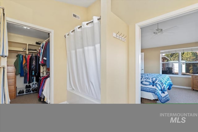 bathroom featuring shower / bathtub combination with curtain and ceiling fan