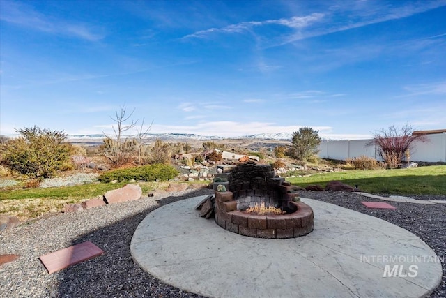 view of yard with a mountain view, a patio, and a fire pit