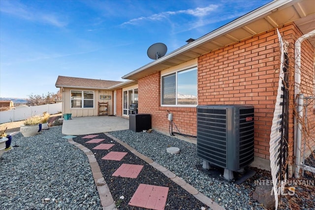 rear view of house with a patio and cooling unit