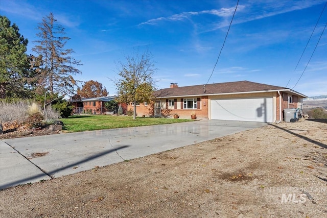 ranch-style home with a garage and a front lawn