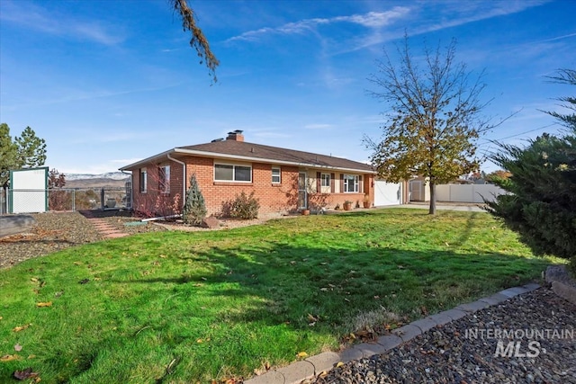 single story home with a garage and a front lawn