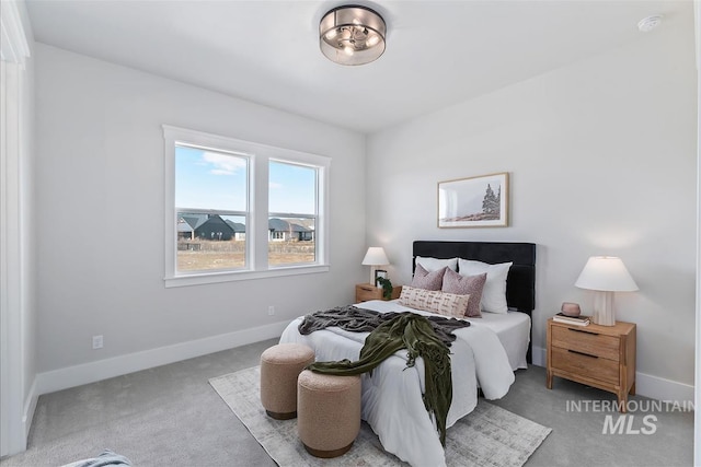 bedroom featuring carpet flooring and baseboards