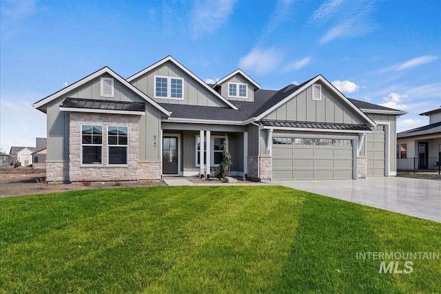 craftsman house with an attached garage, concrete driveway, board and batten siding, a front lawn, and a standing seam roof