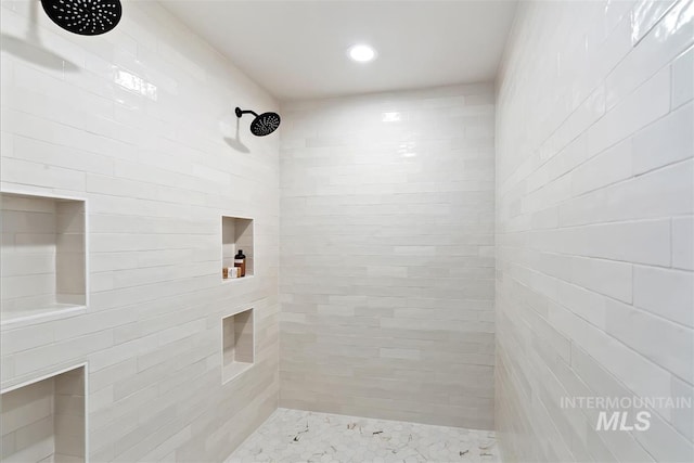 bathroom with a tile shower