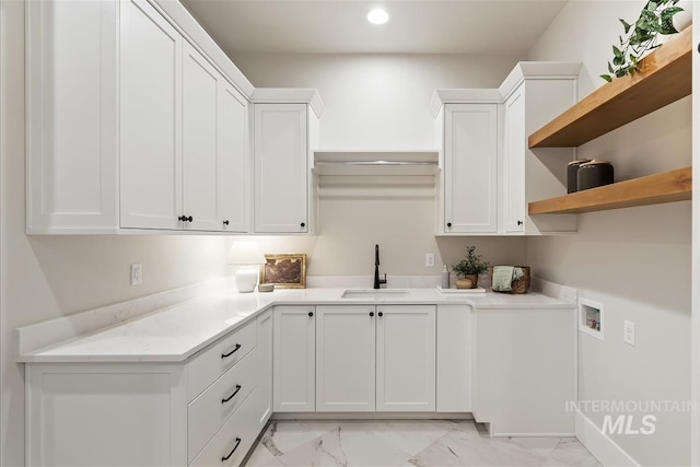 kitchen with marble finish floor, white cabinetry, open shelves, and a sink