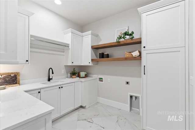 laundry area featuring recessed lighting, hookup for an electric dryer, a sink, marble finish floor, and cabinet space