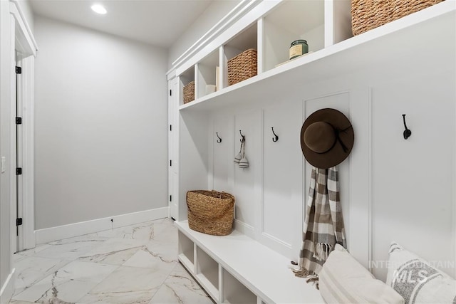 mudroom with marble finish floor, recessed lighting, and baseboards