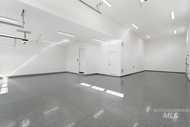 garage featuring baseboards and a garage door opener