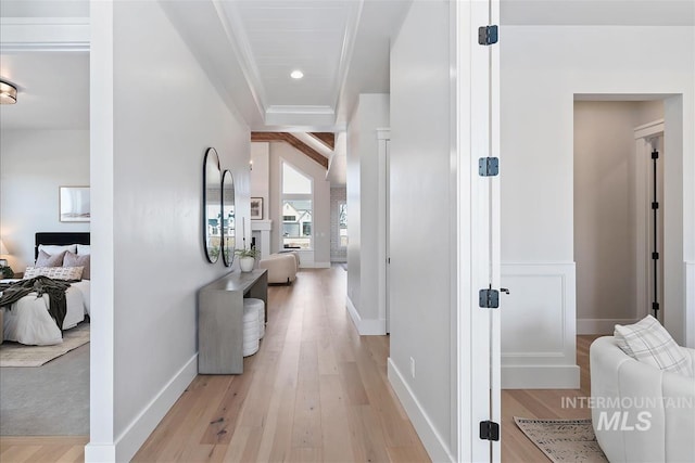 corridor featuring light wood-style flooring, baseboards, and recessed lighting