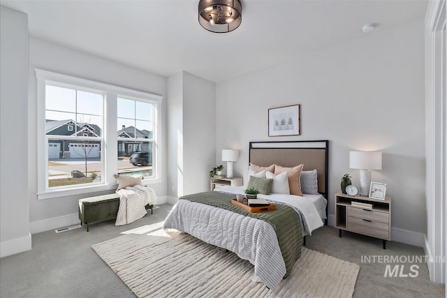 carpeted bedroom featuring baseboards