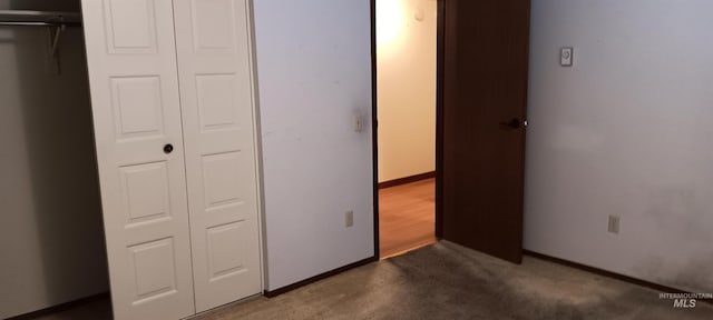 unfurnished bedroom featuring carpet and a closet