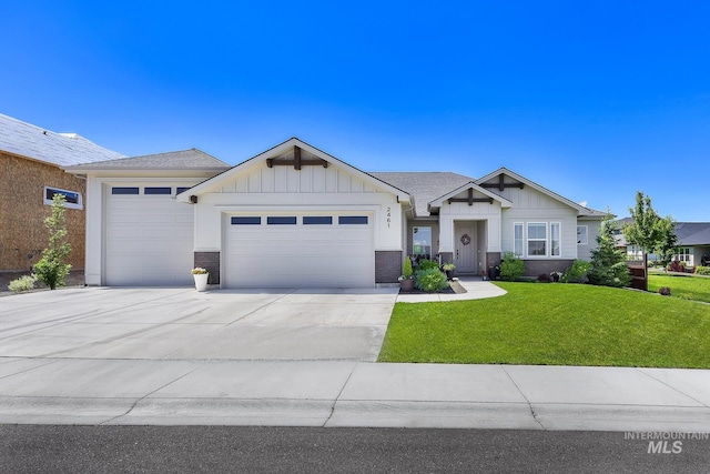 2461 S Cordillera Way, Nampa, ID 83686 - view of front facade featuring an attached garage, board and batten siding, concrete driveway, a front lawn, and brick siding