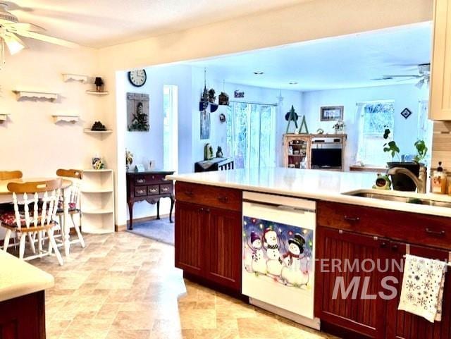 kitchen featuring ceiling fan, a healthy amount of sunlight, beverage cooler, and sink