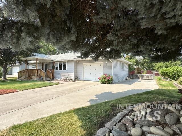 view of front of home with a garage and a front lawn