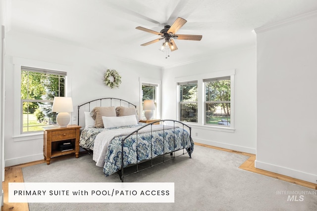 bedroom with hardwood / wood-style floors, crown molding, and ceiling fan